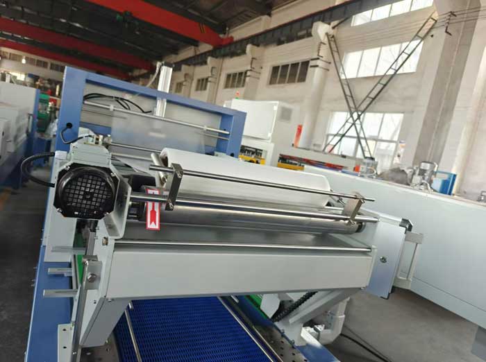 Delivery of film for linear shrink packing machine