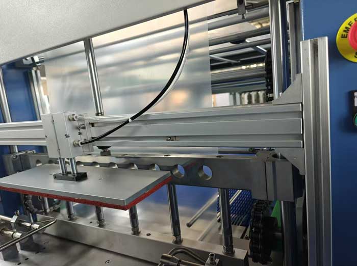 Heat shrink wrapper pressing section can be adjusted up and down